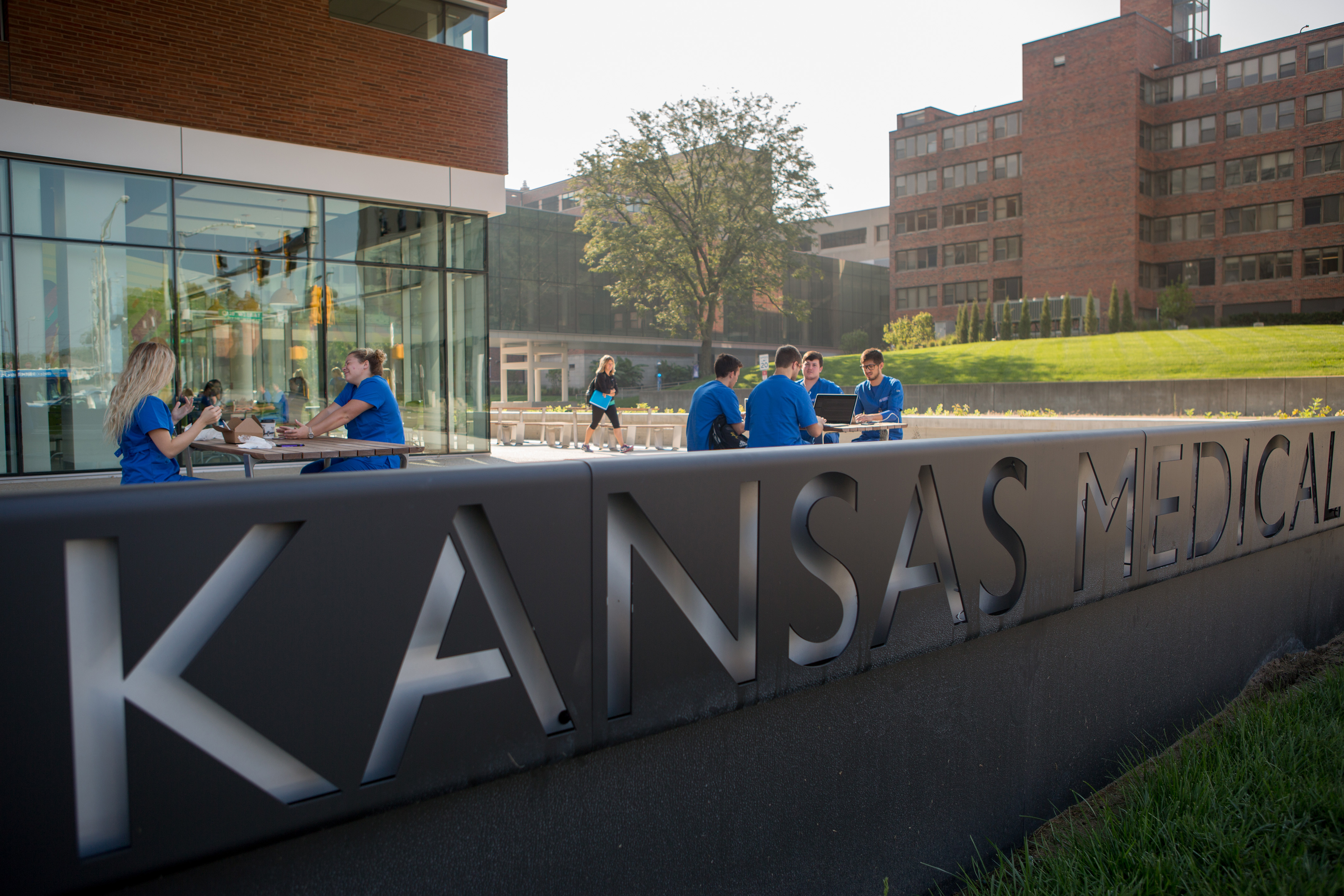 Student nurses sitting outside the Health Education Building on the KU Medical Center campus